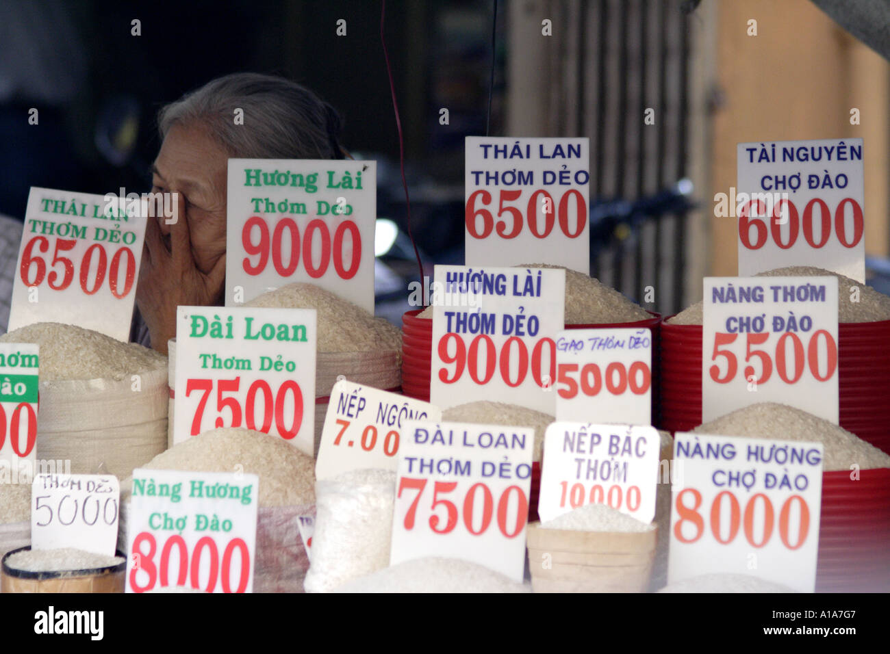 Selling Rice Signage Old woman selling rice and grain in Saigon (HCMC), Vietnam Stock Photo ...