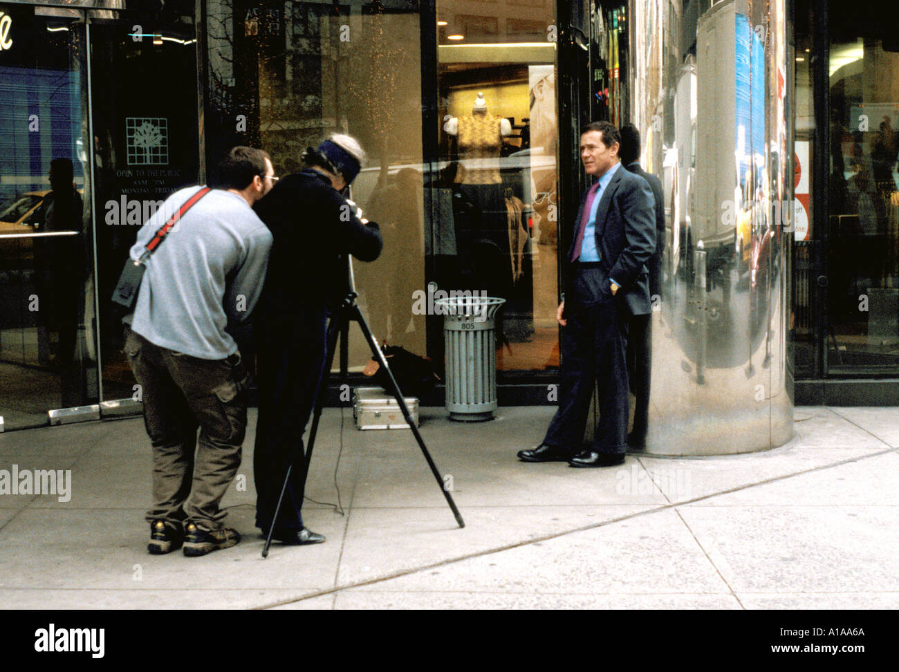 A photographer and his assistant photographing a male fashion model on Fifth Ave New York USA Stock Photo
