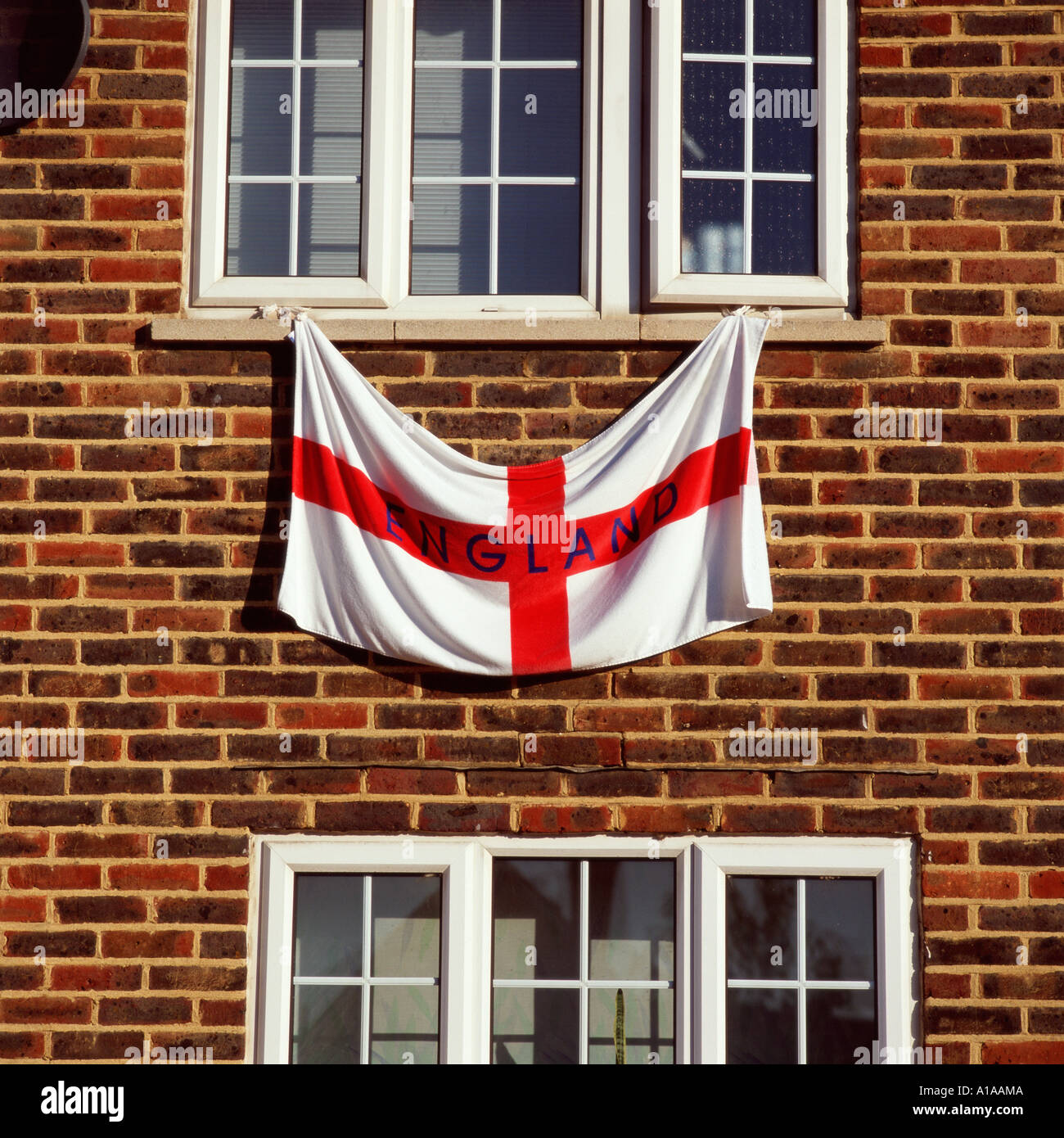 England flag hanging from a window Stock Photo