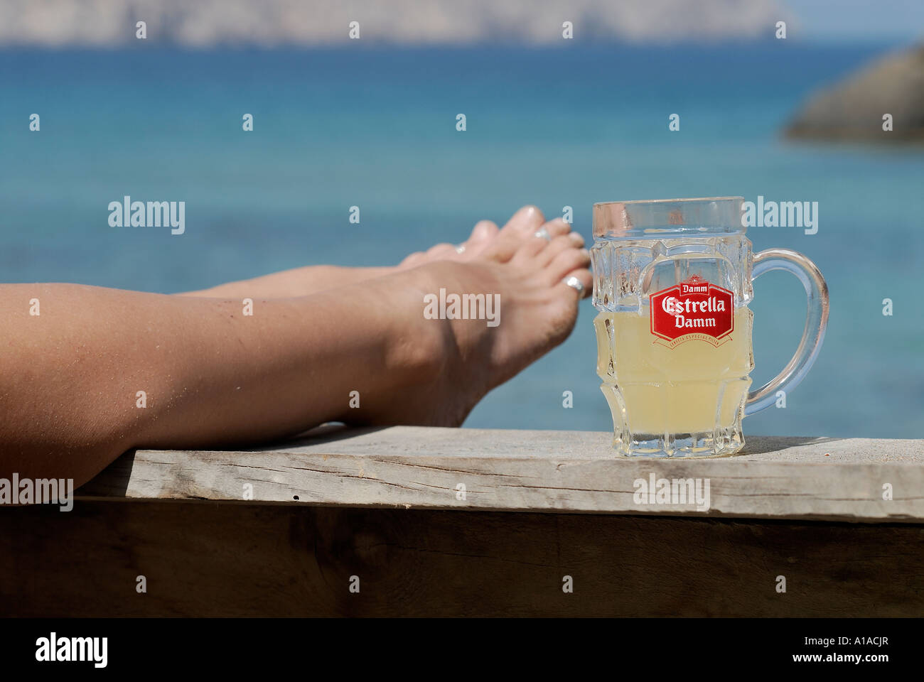 Feet with an Estrella beer glass , Ibiza , Balearis Islands , Spain , Europe Stock Photo