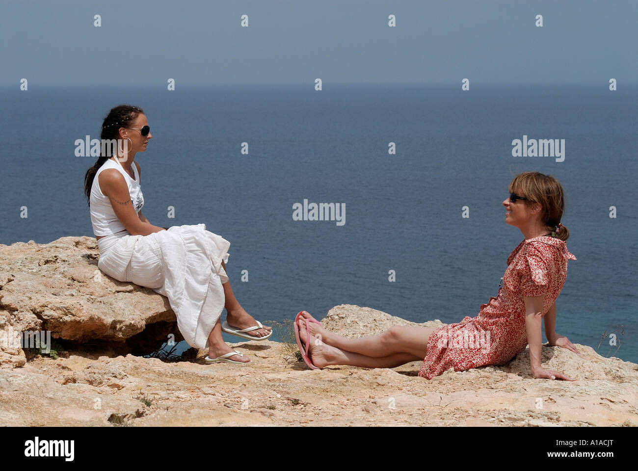 2 friends at the coast , Ibiza , Balearis Islands , Spain , Europe Stock Photo