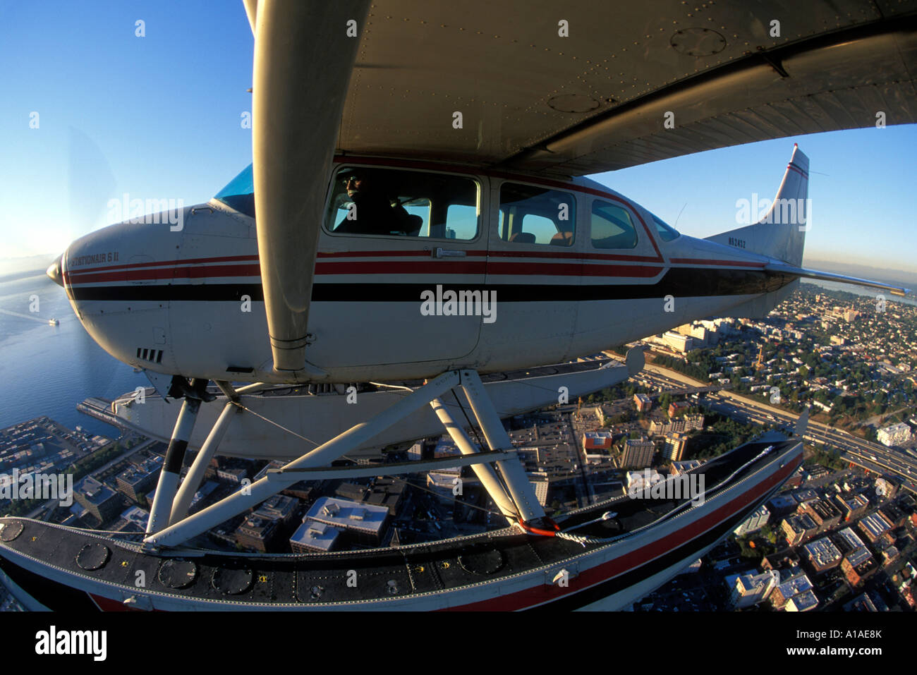 USA, Washington, Seattle, (MR) Jim Chrysler pilots a Cessna 206 floatplane  above Montlake Cut on sunny afternoon