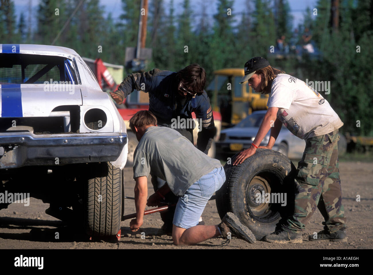 USA Alaska Fairbanks Pit crew works to repair flat tire on sprint car