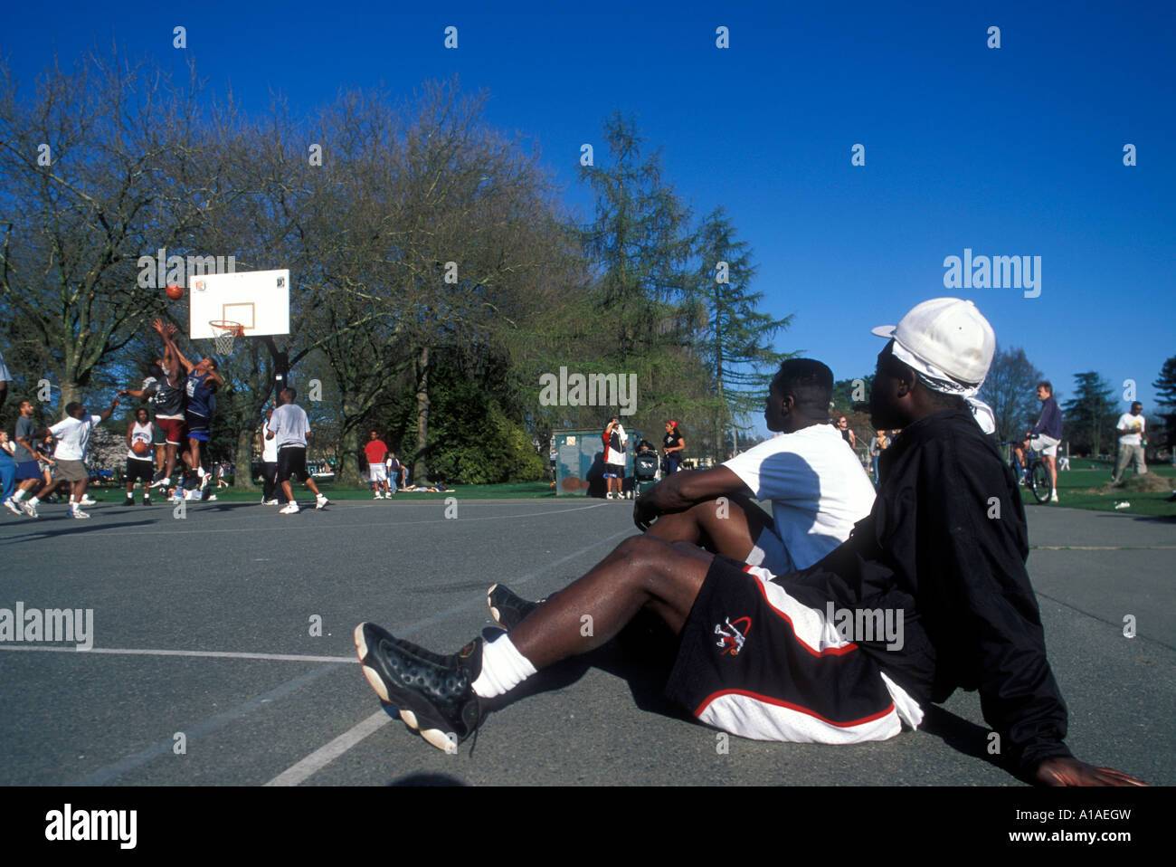 USA Washington Seattle Men watch pickup basketball game in playgrounds