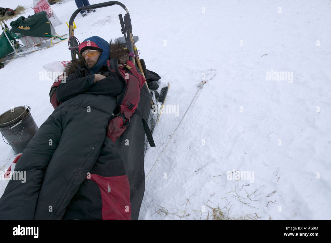 USA Alaska Musher Lance Mackey sleeps on top of his sled on snow