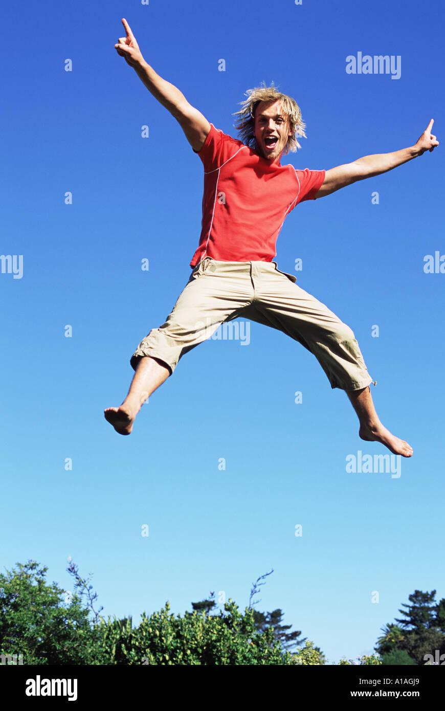 Young man jumping Stock Photo - Alamy
