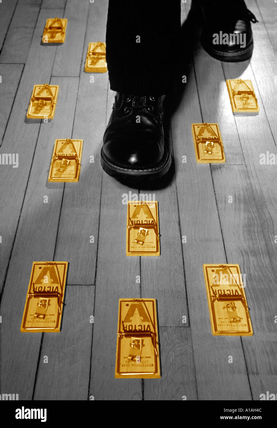 Feet surrounded by mousetraps Stock Photo