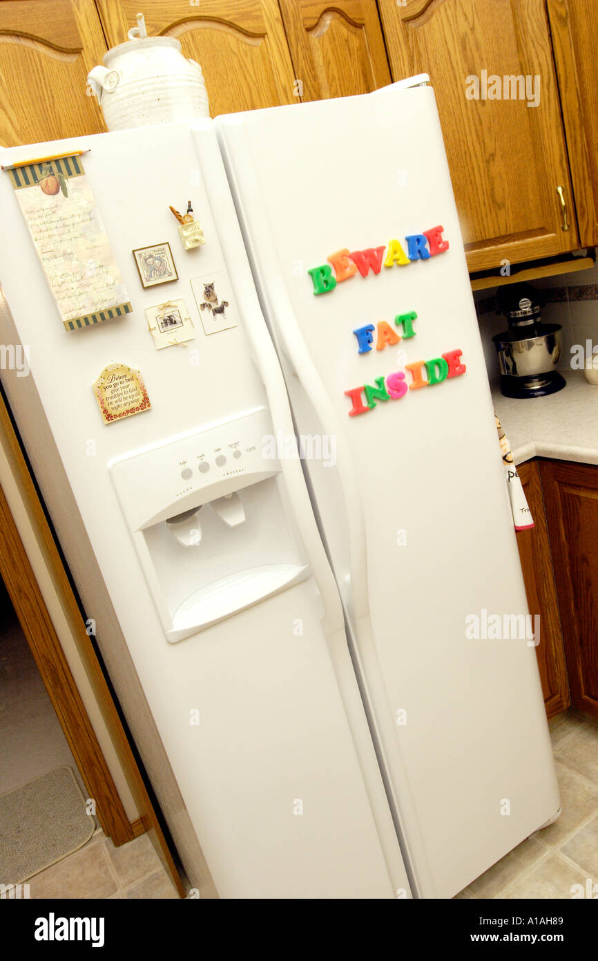 Refridgerator with magnetic letters spelling Beware fat inside Stock Photo