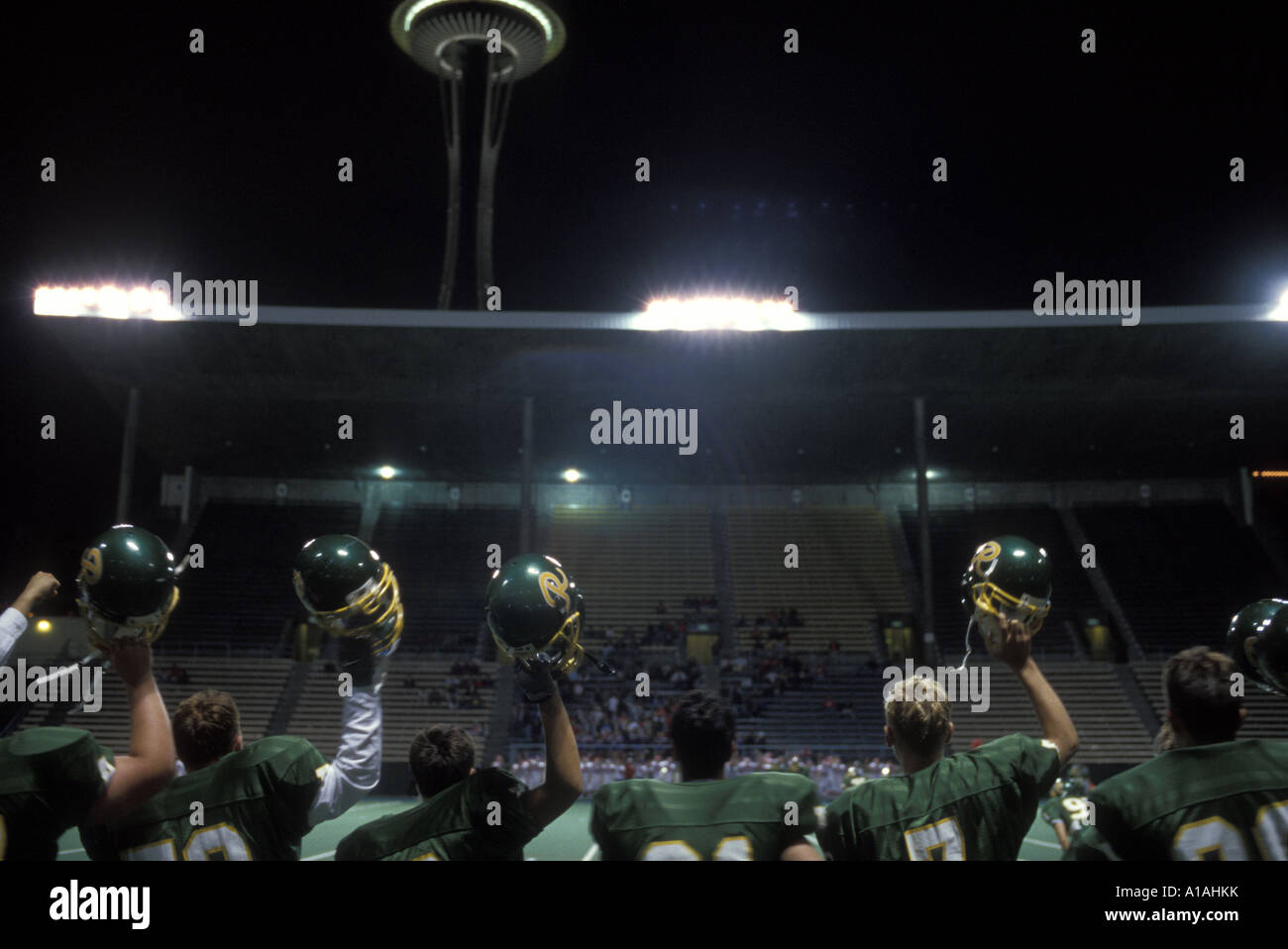 USA Washington Seattle Roosevelt High football team holds helmets up