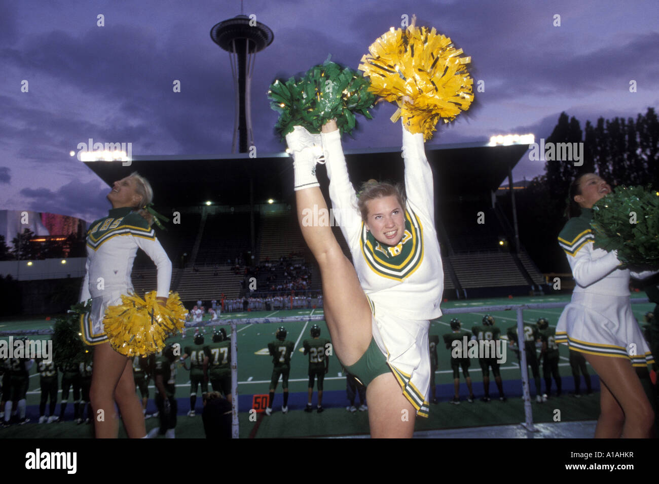 USA, Washington, Seattle, Roosevelt High School cheerleaders at Friday night football game in Memorial Stadium Stock Photo