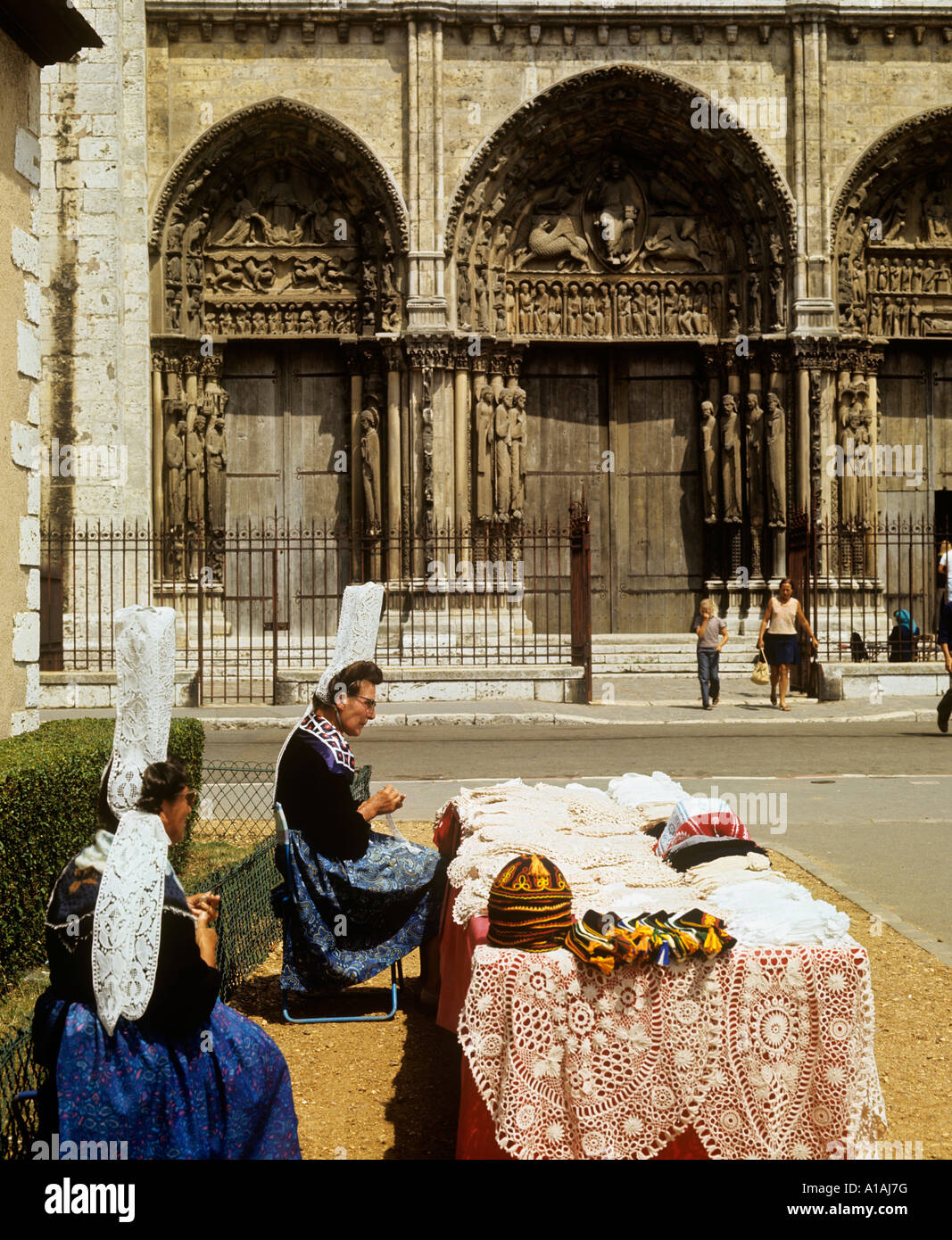 Lace makers wearing traditional Breton costume working their trade at a stall outside Chartres Cathedral Stock Photo