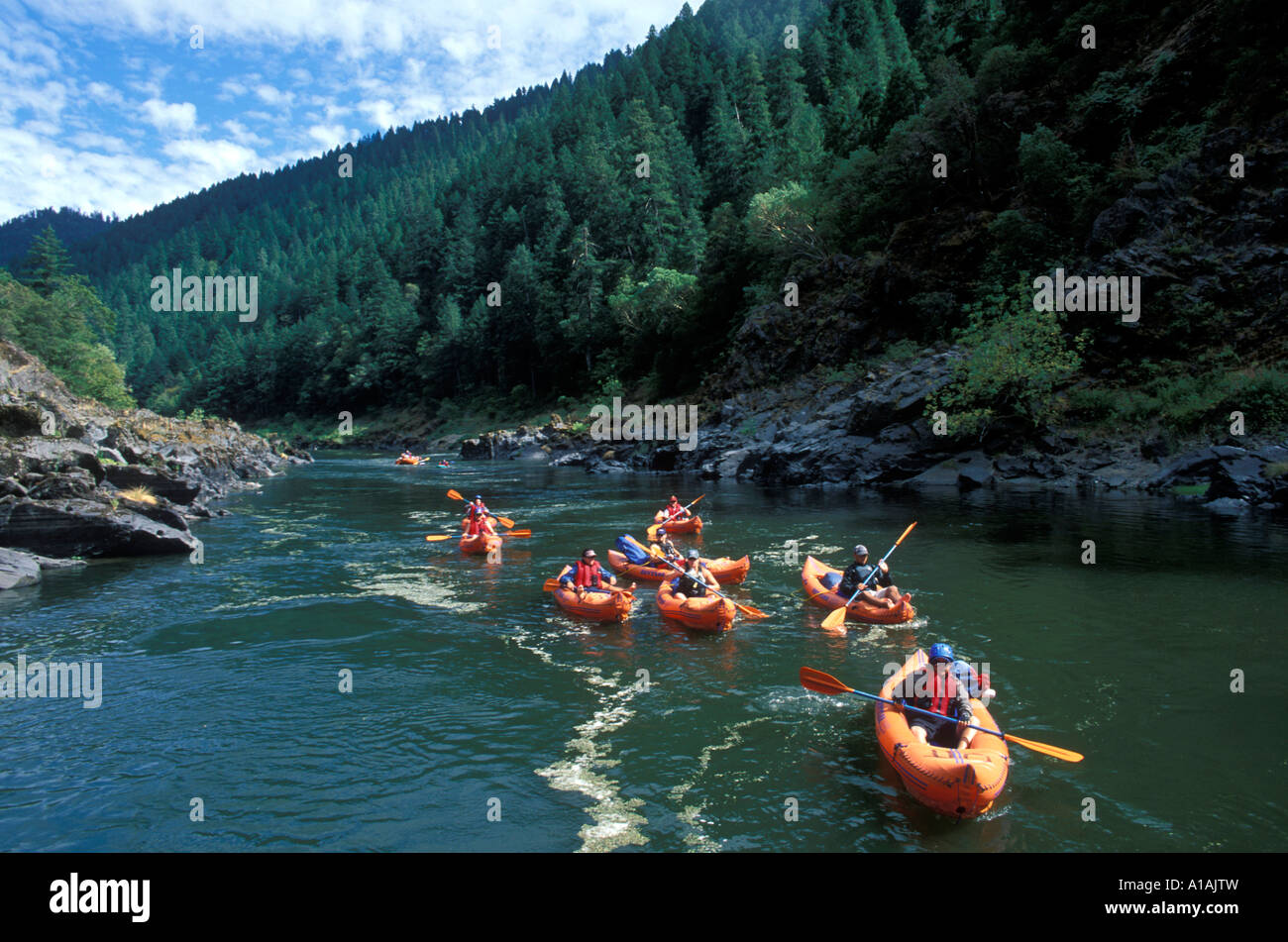 USA Oregon Rogue National Wild and Scenic River Paddlers on Orange Torpedo Tour kayak down Rogue