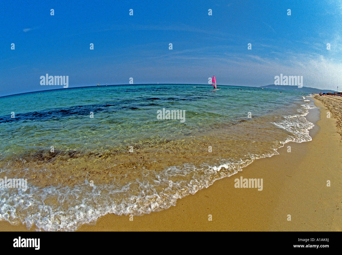 Shallow azure waters off Tahiti Beach near St Tropez are ideal for gentle windsurfing Stock Photo
