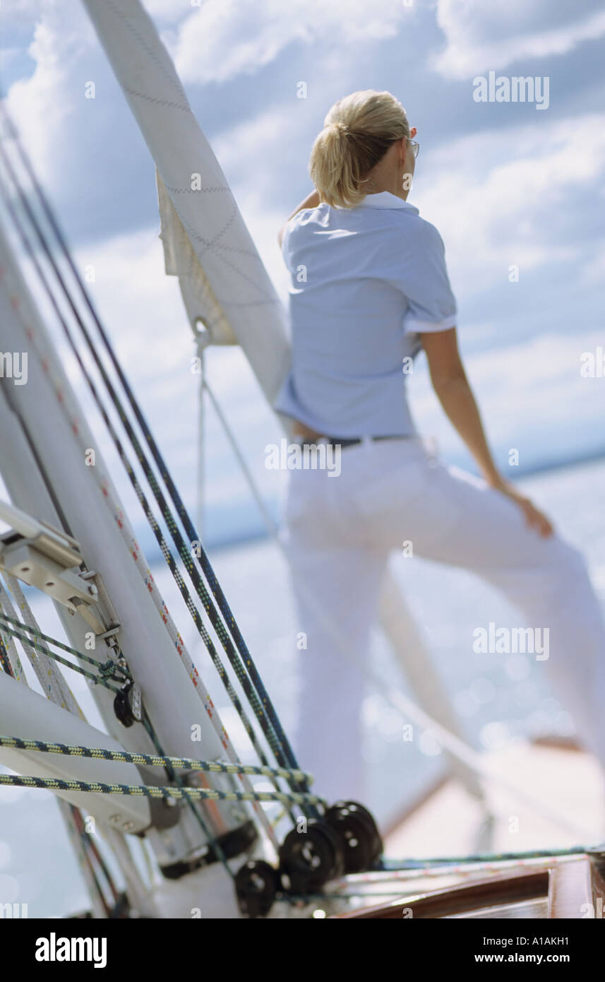 Rear view of woman on boat looking out to sea Stock Photo