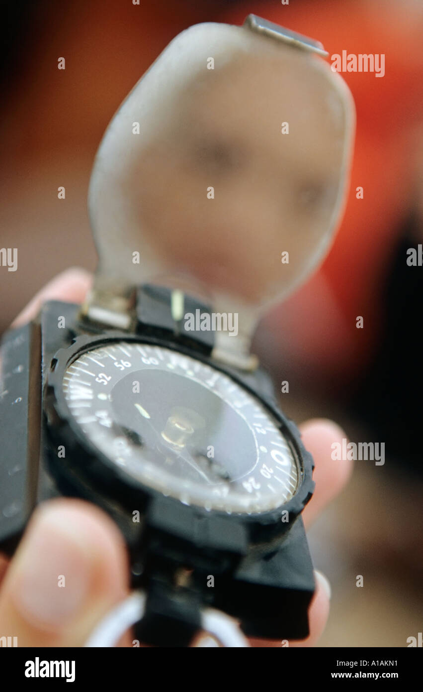 Close-up of person holding compass Stock Photo