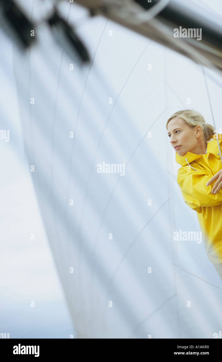 Woman in yellow raincoat on boat Stock Photo