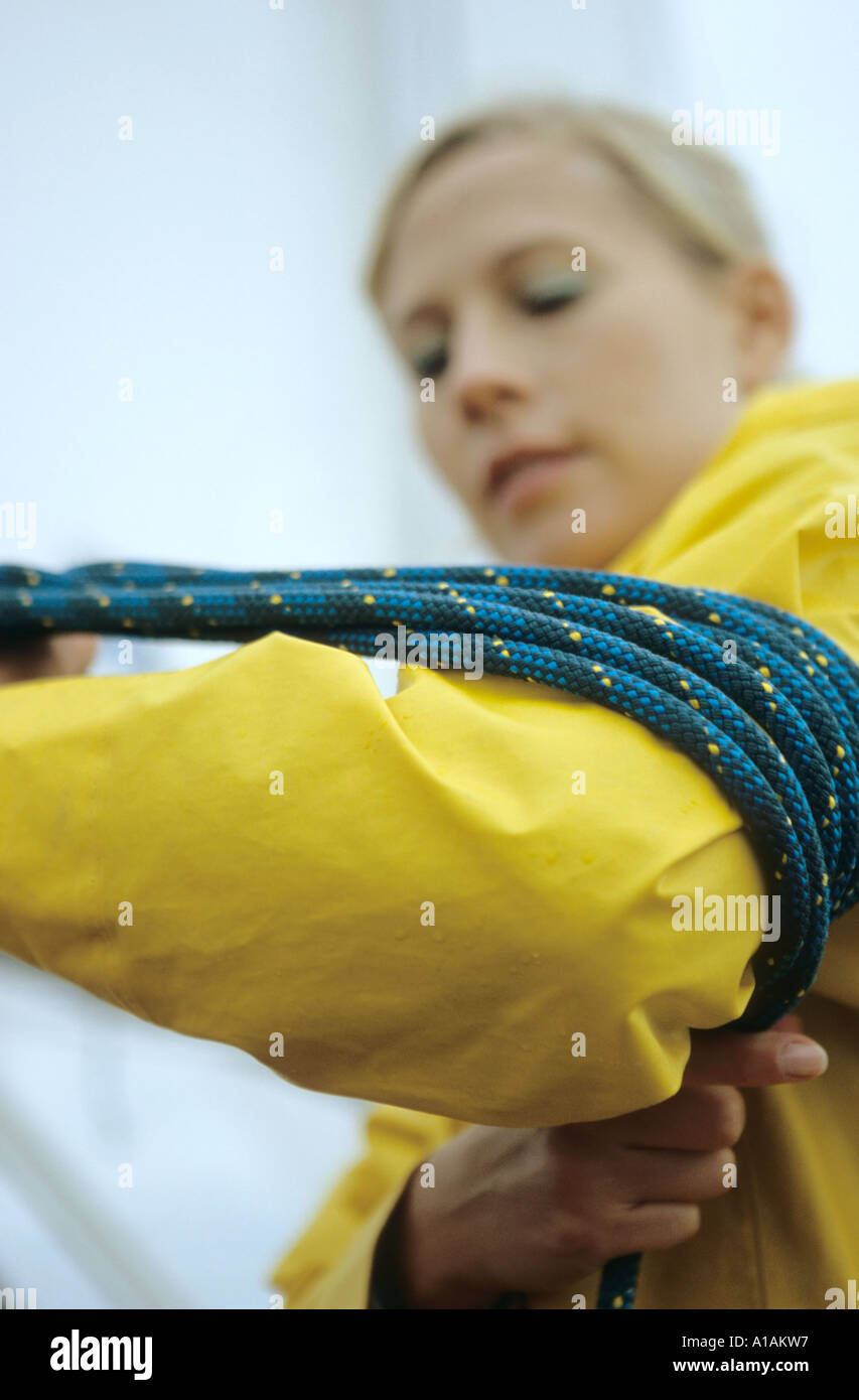 Woman winding rope around her arm Stock Photo