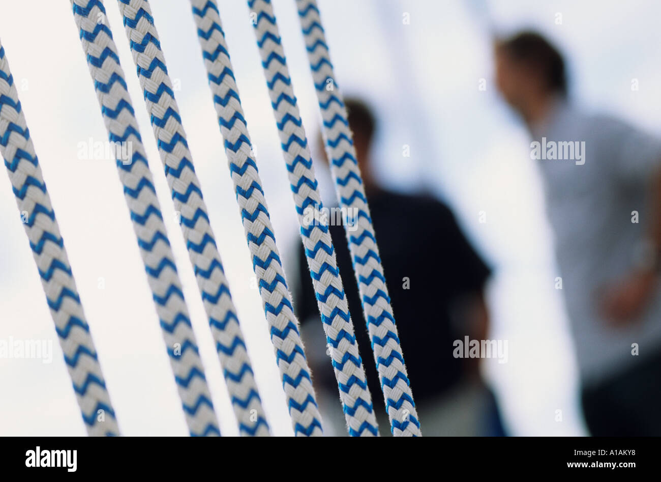 Close-up of rope with two people in background Stock Photo