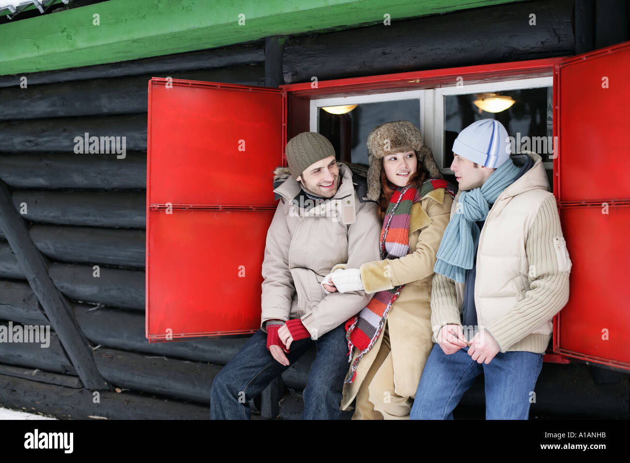 Friends outside a wooden hut Stock Photo