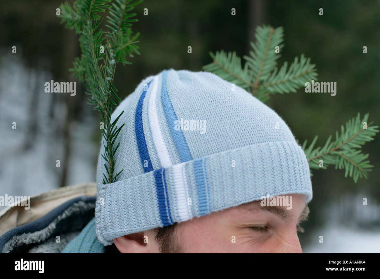 Man with pieces of tree in his hat Stock Photo