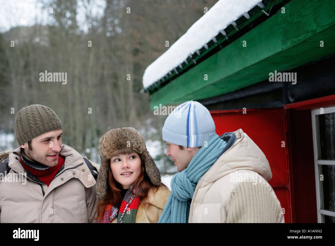 Friends talking outside a hut Stock Photo