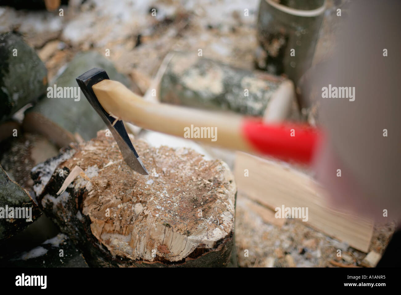 Person chopping logs Stock Photo