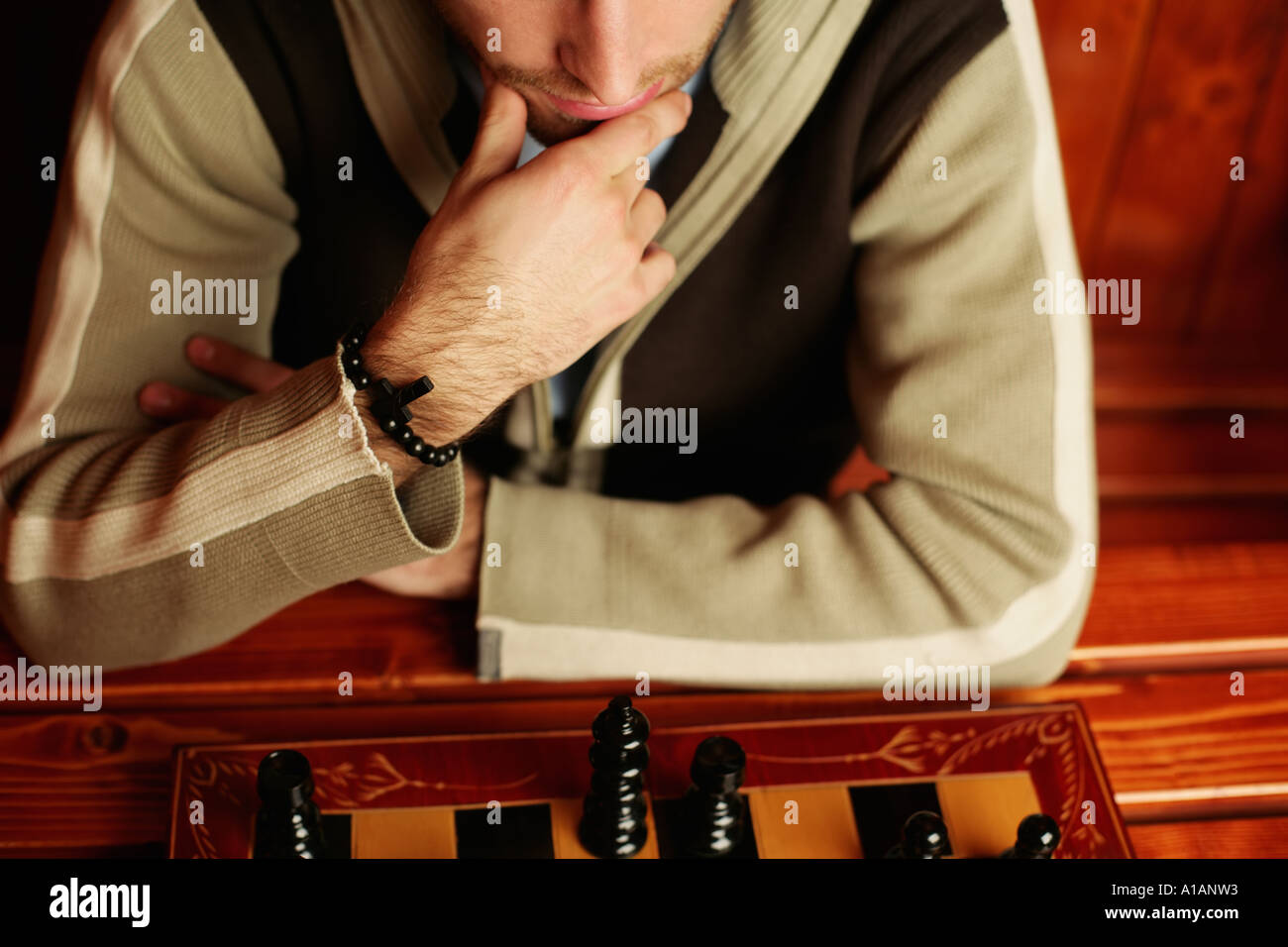 Man contemplating chess move Stock Photo