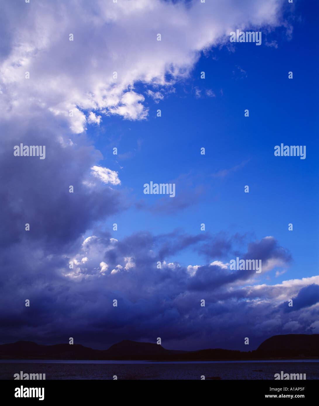 Blue sky with passing storm over mountains and sea, Kintail, Highland, Scotland Stock Photo