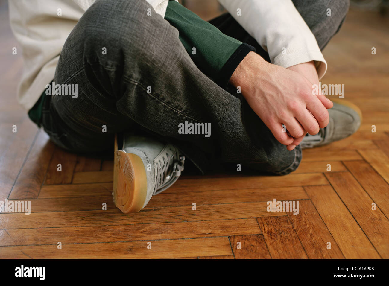 Man sitting crosslegged on the floor Stock Photo Alamy
