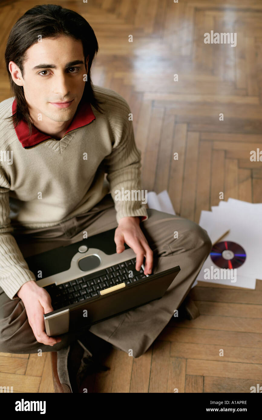 Man sitting on the floor with laptop Stock Photo - Alamy