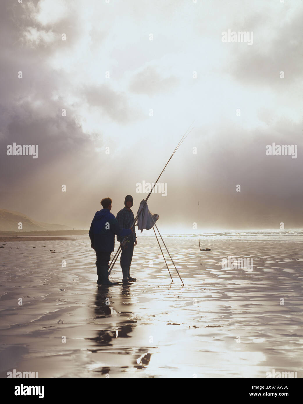 two sea fishermen standing on the atlantic foreshore on irelands scenic west coast Stock Photo