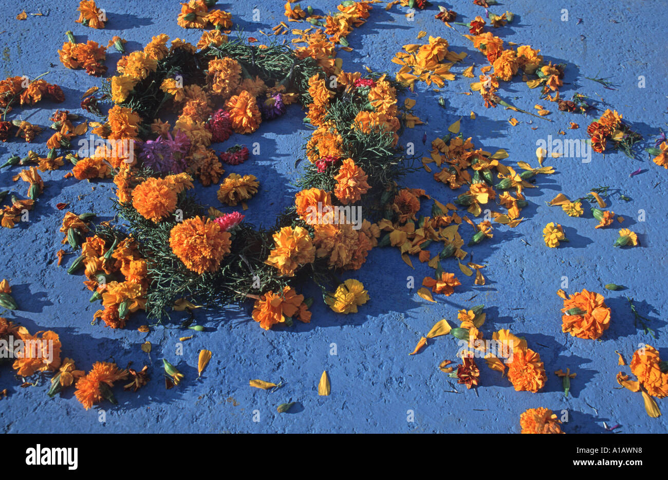Flowers scattered on a colourfully painted tomb in the graveyard at