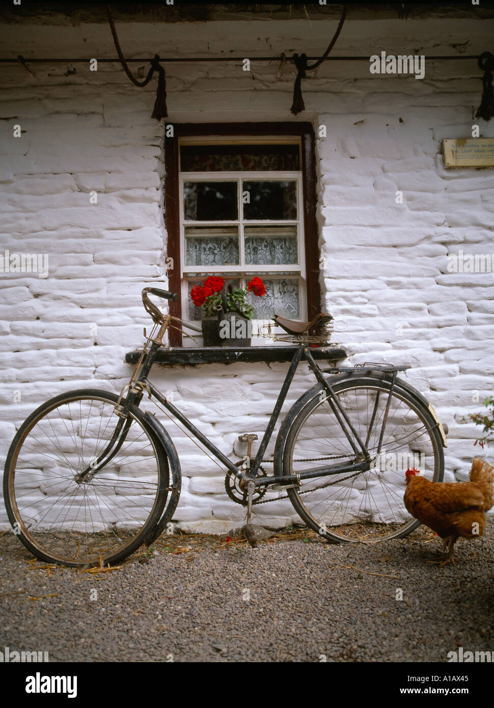 traditional thatched dwelling house in a irish village landscape Stock
