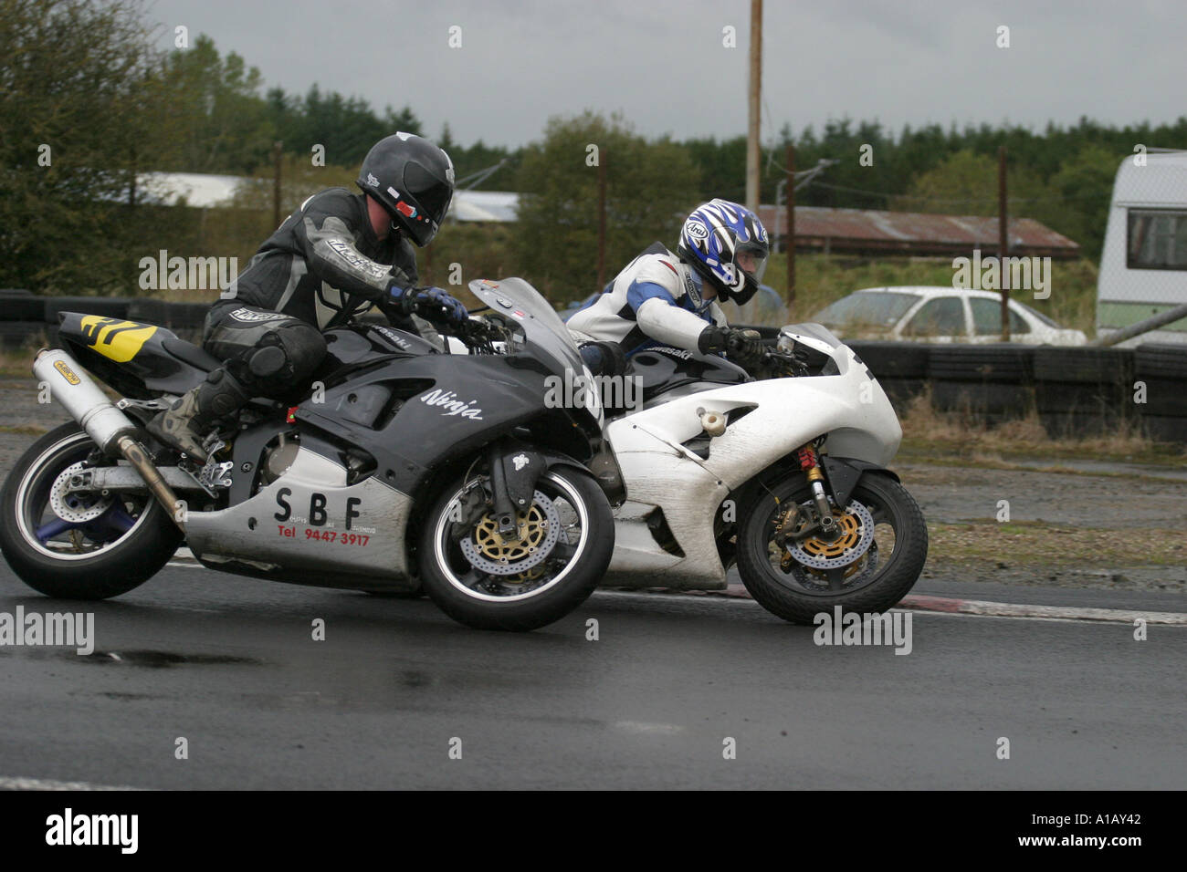two Motorcycle race riders taking a bend at a wet Aghadowey Motorsport