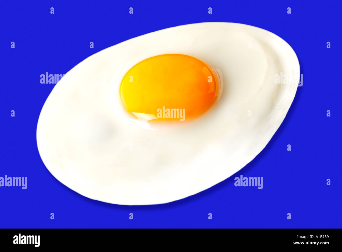 FRIED EGG ON BLUE Stock Photo