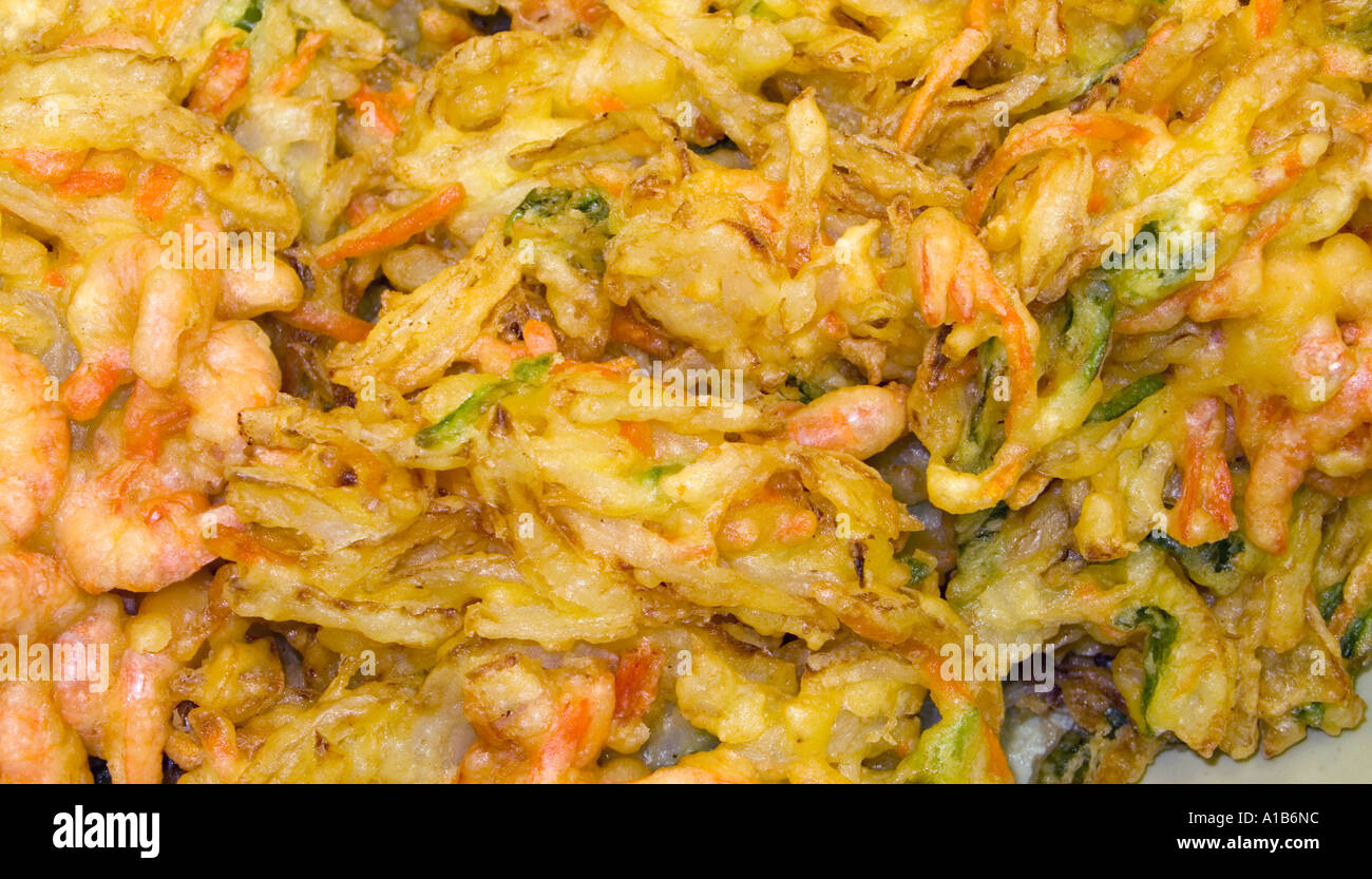 Battered and fried vegetables mixed with seafood for sale at a food