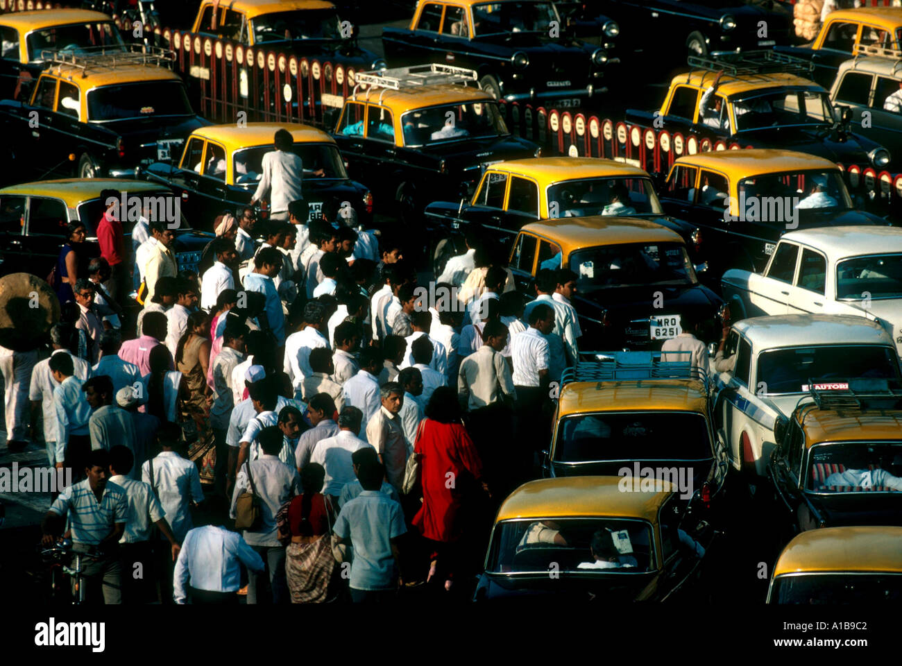 Crowds mingle in with rush hour traffic jam near Victoria Terminus