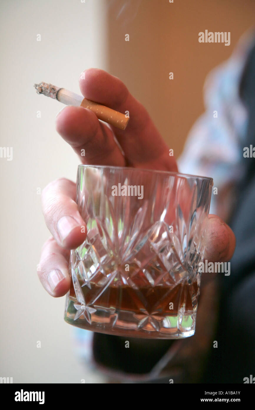 man holding whisky glass and cigarette Stock Photo