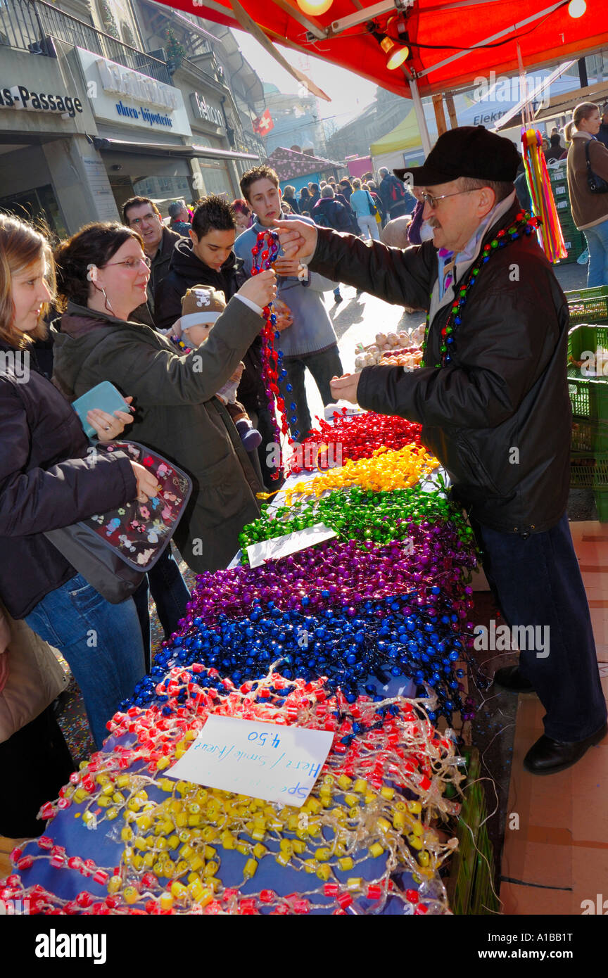 A vendor selling chains of sweets at Bern's onion market (Zweibelmarkt ...