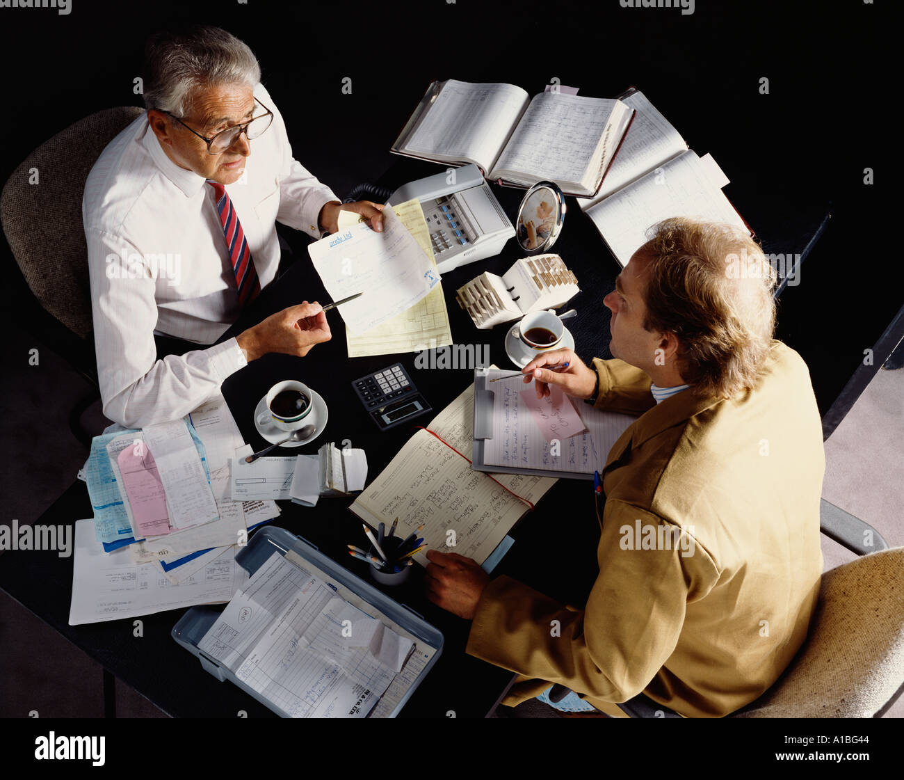 Men sitting across table at meeting Stock Photo Alamy