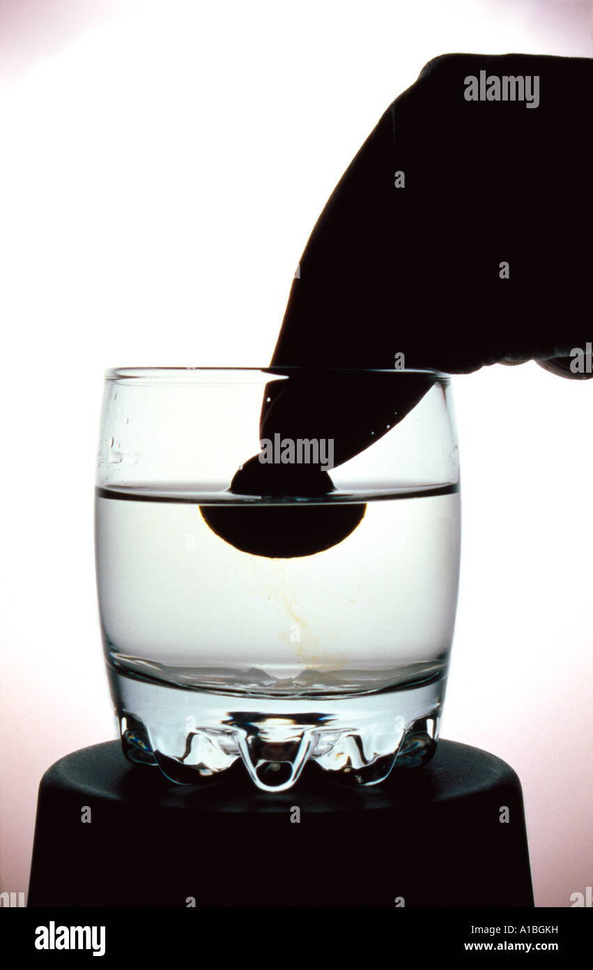 glass of water over a white background with effervescent pills Stock Photo