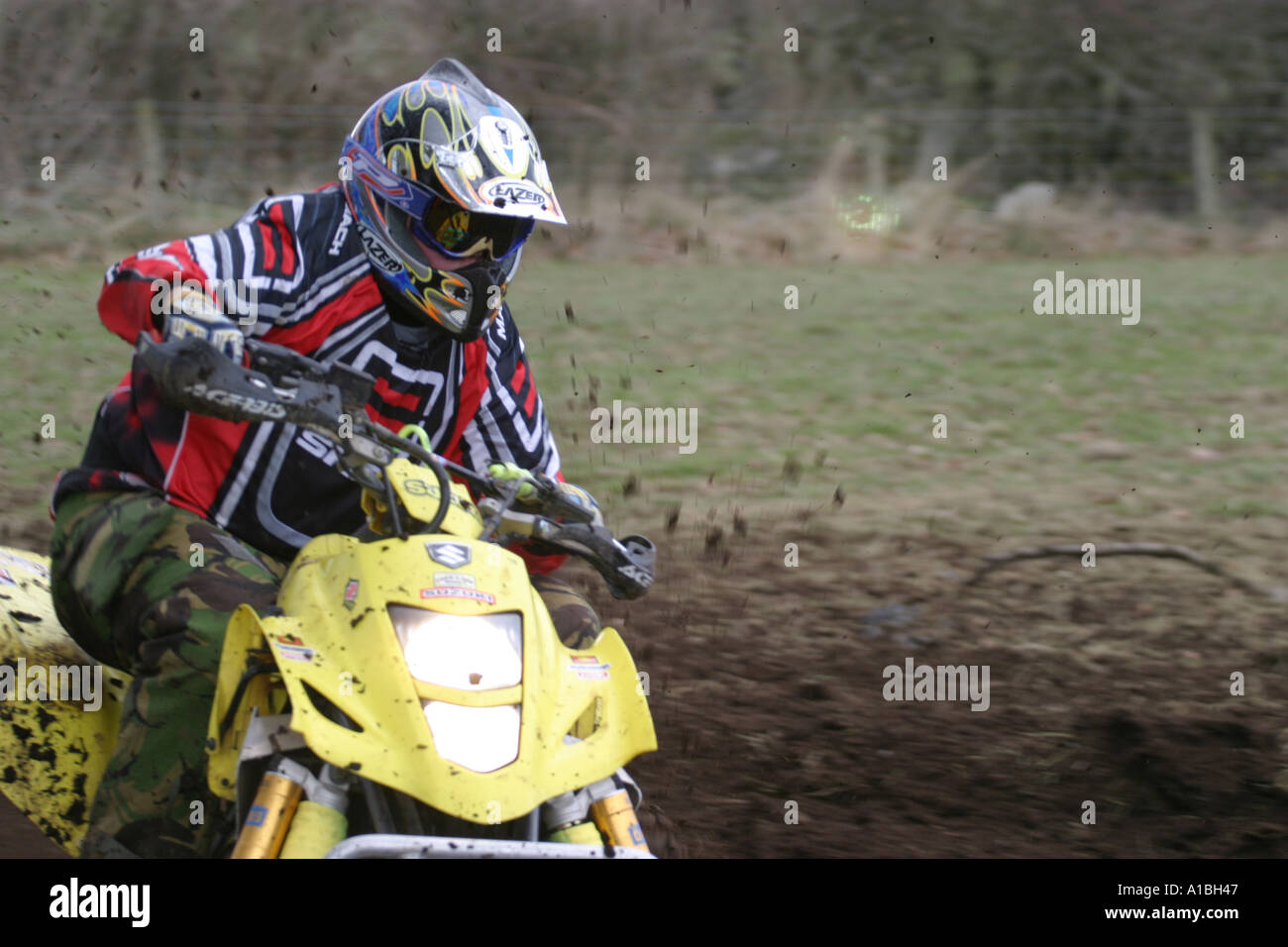 Quad Racing Yellow Quad Racer in action on yellow quad bike with headlight shining outside ...