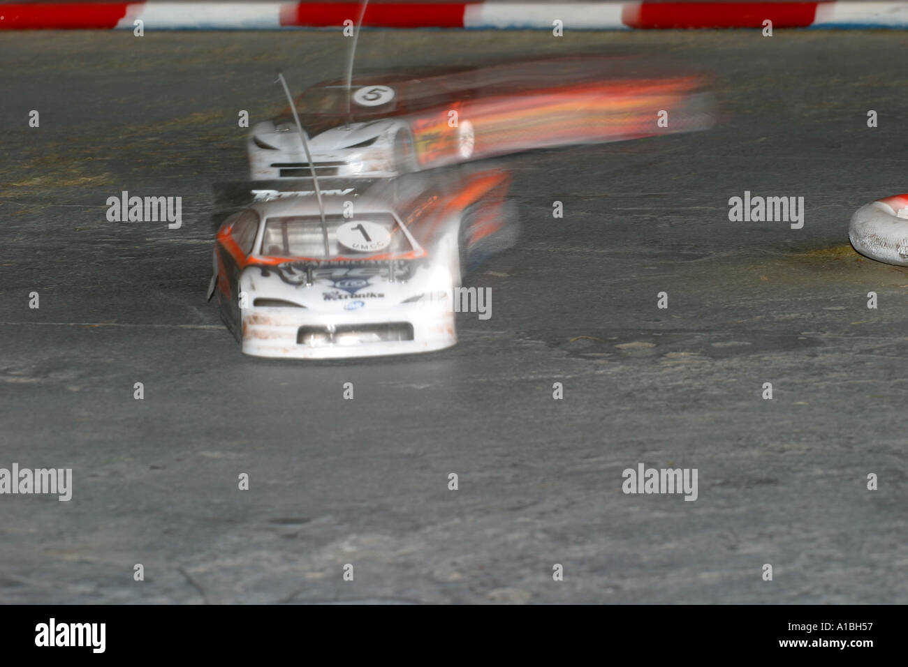 saloon car radio control car racing two cars streak round a chicane