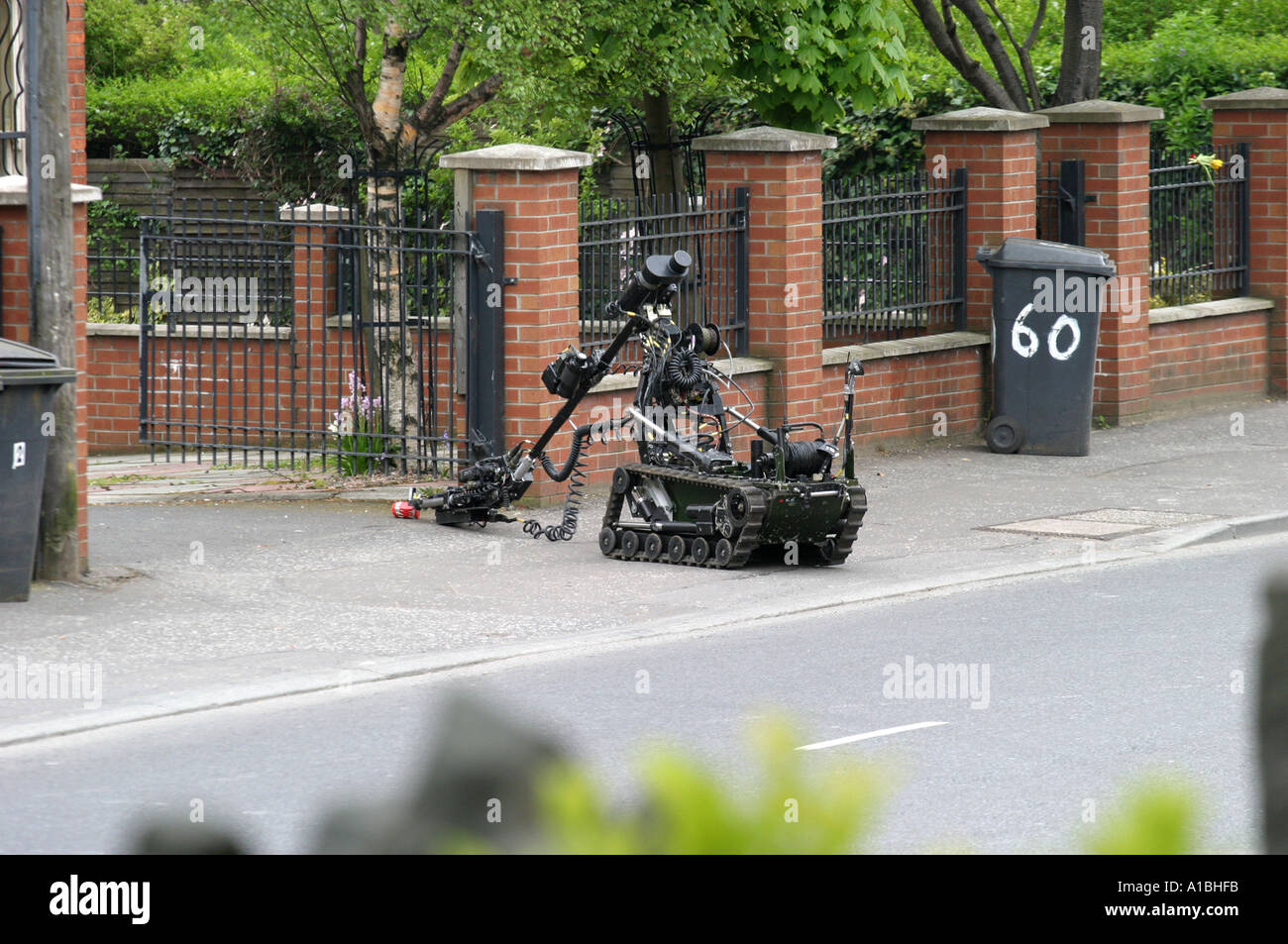 British Army Bomb disposal robot approaches an improvised hoax terrorist republican Real IRA explosive device Andersonstown Road Stock Photo