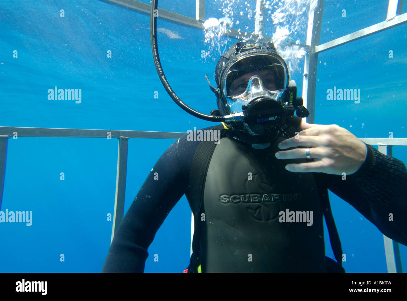 A scuba diver wearing a full face mask fitted with communication