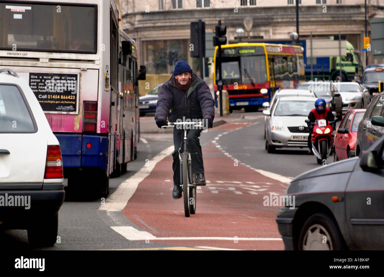 Cyclist using bus lane in Bristol city centre England UK Stock Photo