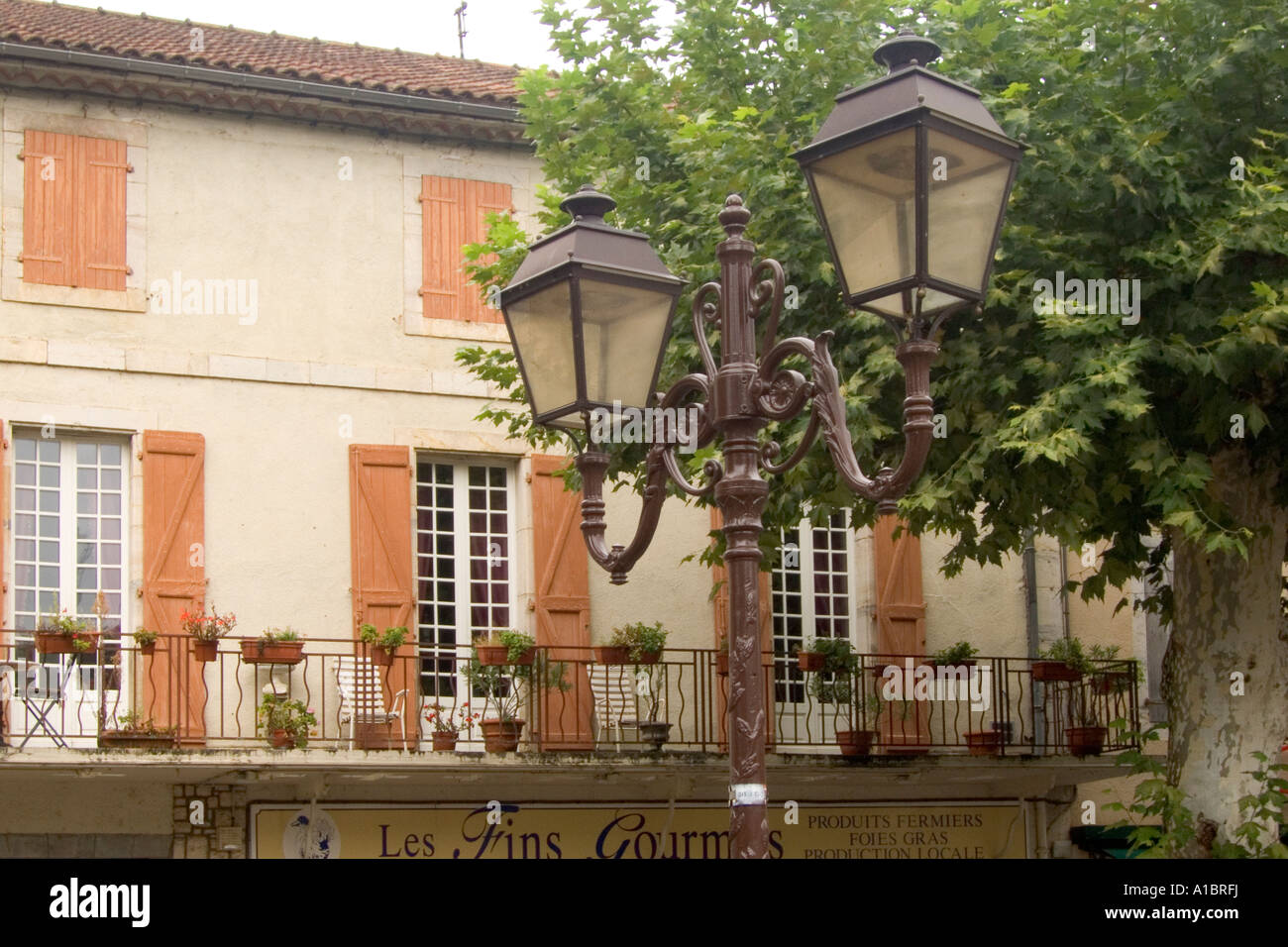 Typical french street lights and shuttered houses around the market