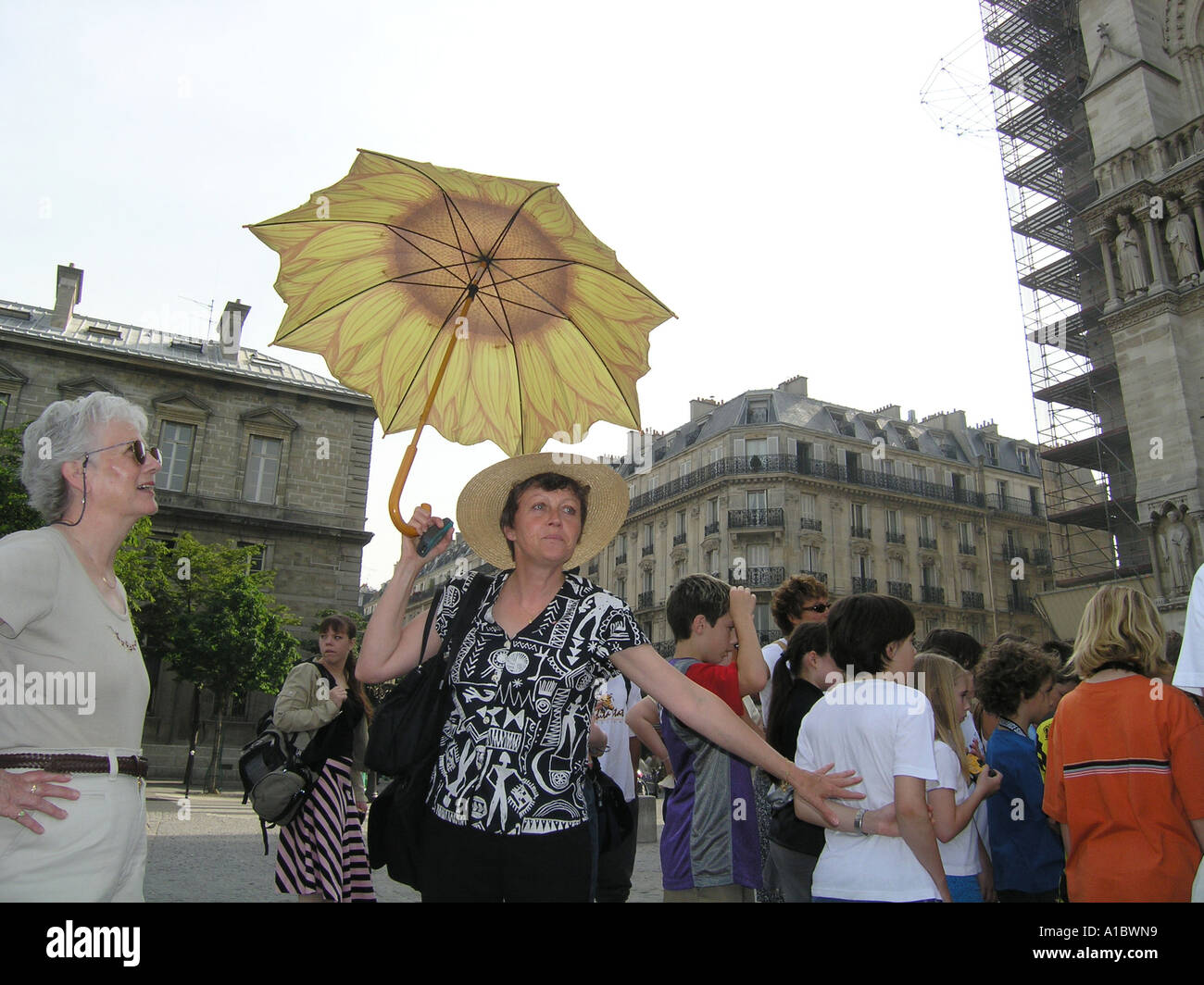 tour guide with umbrella showing tourists around in Paris Stock Photo