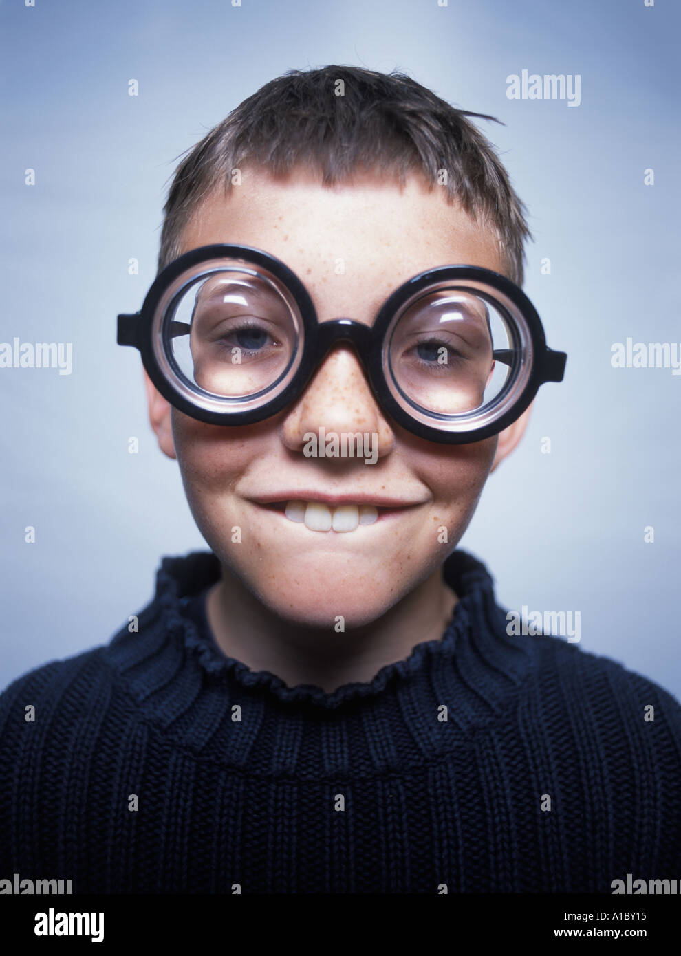 Portrait of a goofy young boy wearing thick glasses Stock Photo