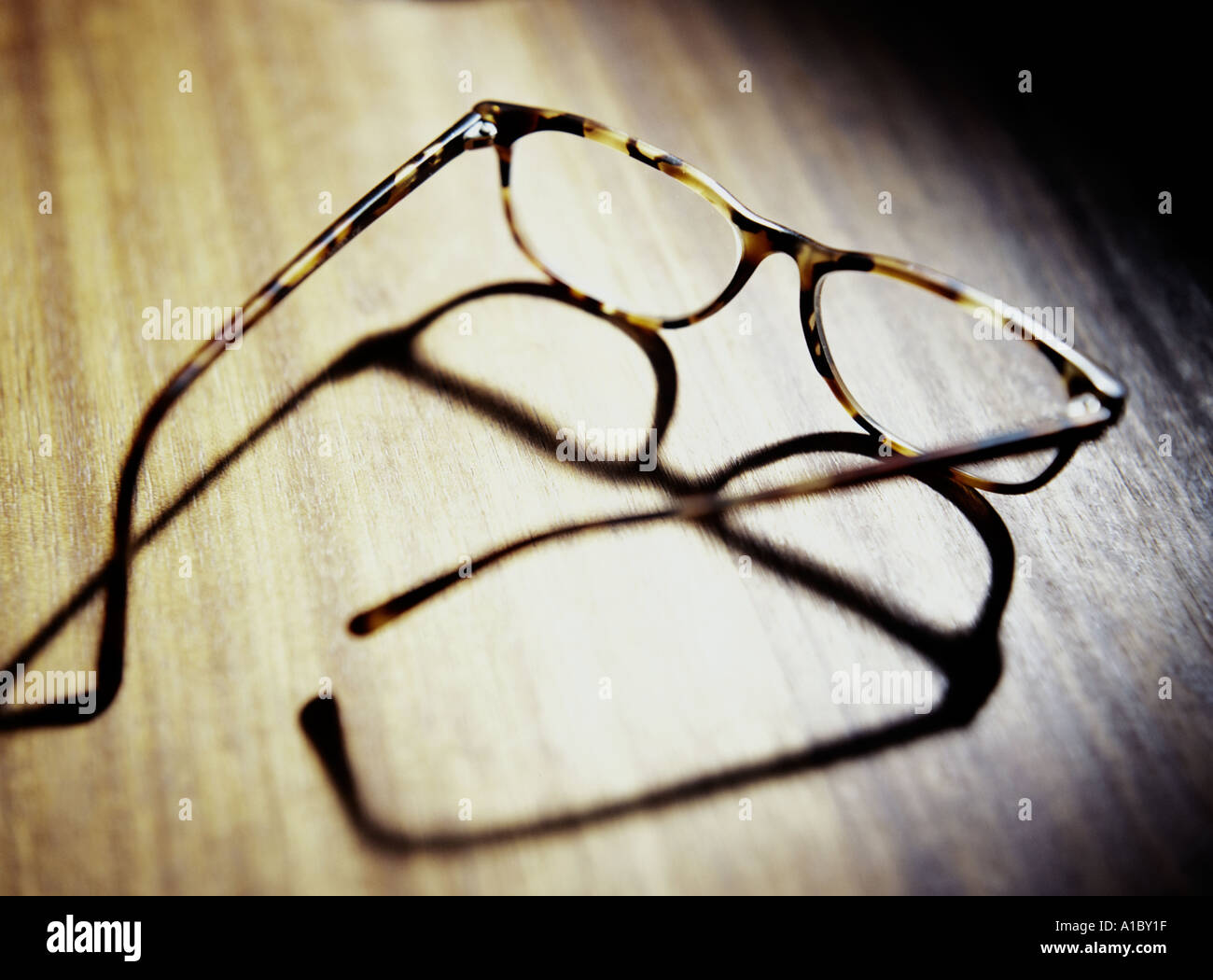 a pair of horn rimmed reading glasses Stock Photo